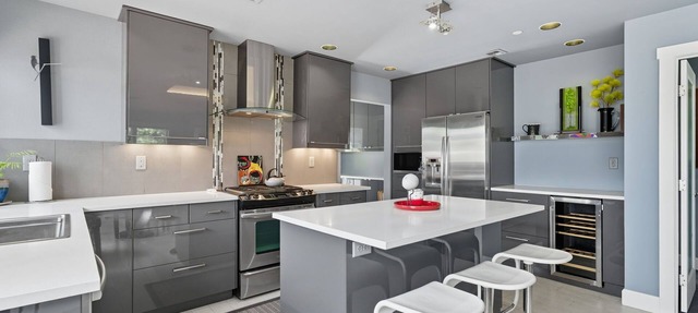 Top-level duplex featuring a sleek open concept kitchen with stainless appliances, cozy fireplace, stylish furnishings, and in-unit washer/dryer. Designed for basking in the sun under skylights in thoughtful details throughout. in Vancouver
